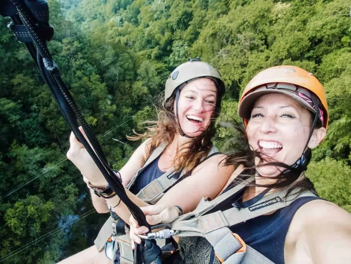 girls ziplining laughing