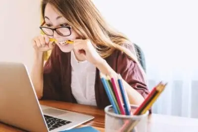 student girl biting pencil