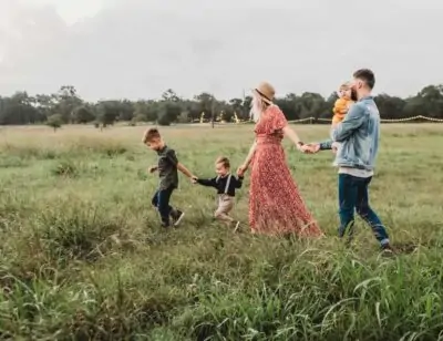 family walking through grass