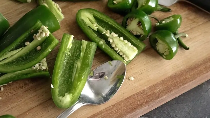 Keto Jalapeno Poppers with Sausage deseeding the peppers