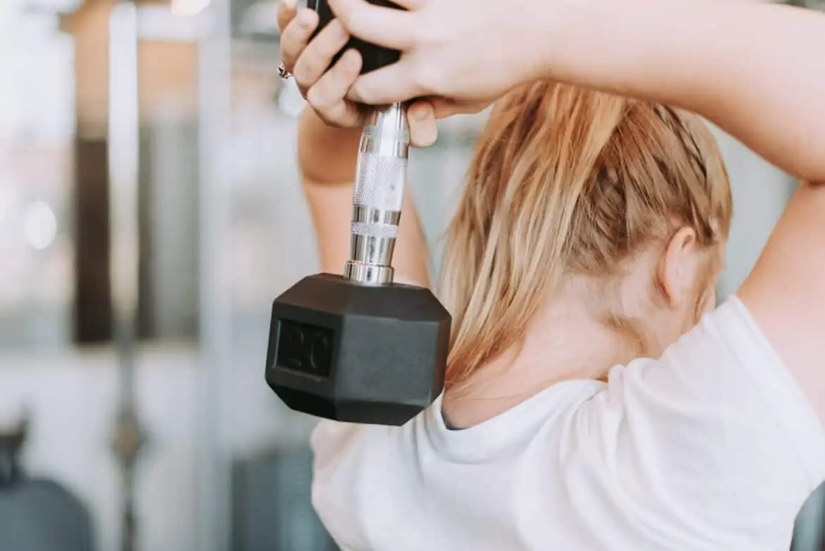 girl doing overhead dumbbell exercise