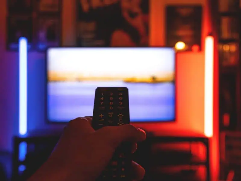 a remote control pointed at TV