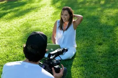 woman sitting on grass getting her photo taken