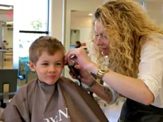 little boy getting a haircut